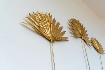 three fake palm leaves on a white background at Vista al Mar in Ribeira Brava