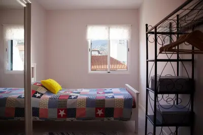 a bedroom with a bed and a ladder at Art House Funchalet in Funchal