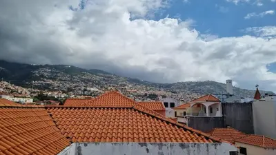 a view of a city with orange roofs at Art House Funchalet in Funchal