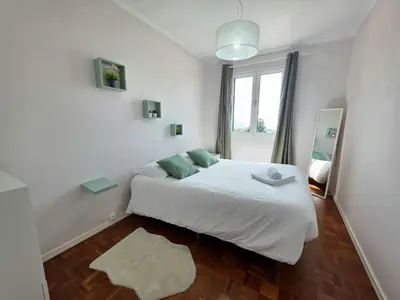 a white bedroom with a bed and a window at Casa Dona by Rentallido in Funchal