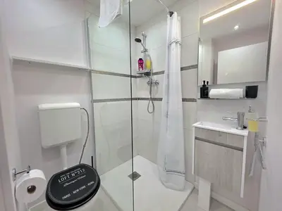a white bathroom with a shower and a sink at Casa Dona by Rentallido in Funchal