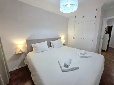 a bedroom with a large white bed with two towels on it at Casa Dona by Rentallido in Funchal