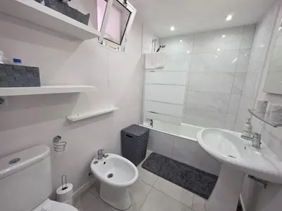 a white bathroom with a toilet and a sink at Casa Dona by Rentallido in Funchal