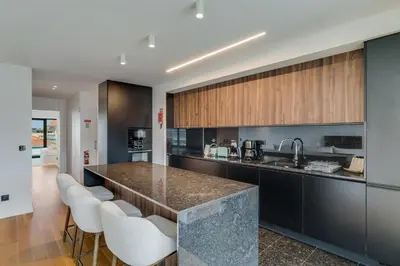an open kitchen with a counter and stools at OceanView Pearl Varino by Holiday Rental Madeira in Funchal