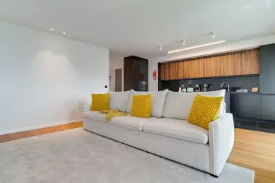 a living room with a white couch with yellow pillows at OceanView Pearl Varino by Holiday Rental Madeira in Funchal