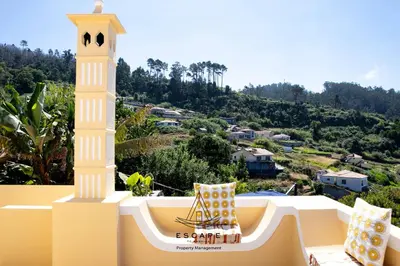 a white balcony with a clock tower on it at Hilltop Hideaway by Escape to Madeira in Arco da Calheta