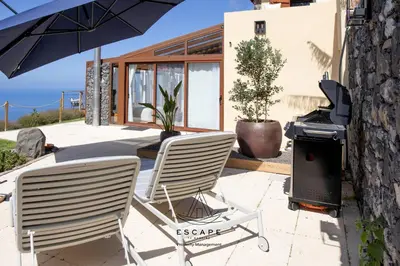two pictures of a room with a rock at Hilltop Hideaway by Escape to Madeira in Arco da Calheta