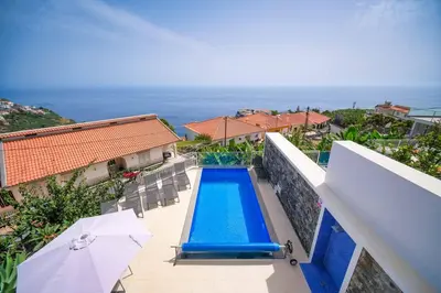a swimming pool on the balcony of a house at Casa dos Amores in Calheta