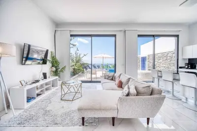 a living room with a couch and a table at Casa dos Amores in Calheta