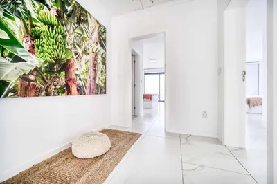 a hallway with a painting of bananas on the wall at Casa das Flores in Calheta