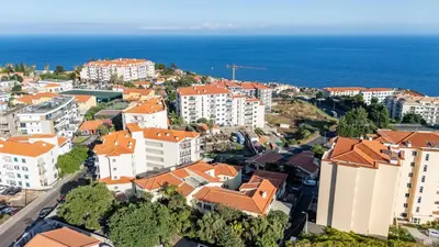 an aerial view of a city with buildings and the ocean at Palm Tree by YOUR KEY in Caniço