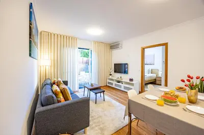 a living room with a couch and a table at Palm Tree by YOUR KEY in Caniço