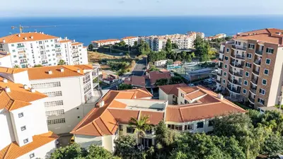 an aerial view of buildings and the ocean at Palm Tree by YOUR KEY in Caniço