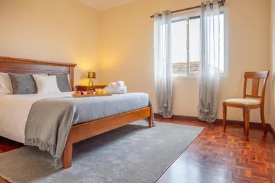 a bedroom with a bed with a tray of fruit on it at Villa Serrão, By OP in Ponta Delgada