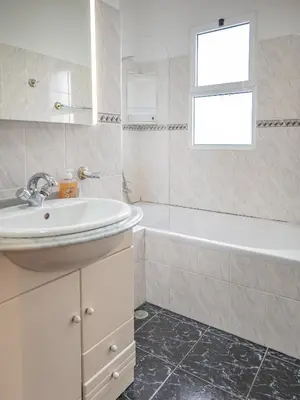 a white bathroom with a sink and a bath tub at Villa Serrão, By OP in Ponta Delgada
