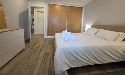 a bedroom with a bed with two pillows on it at Casa Dourada in Câmara de Lobos