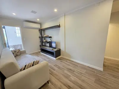 a living room with a couch and a window at Casa Dourada in Câmara de Lobos