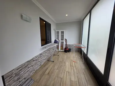 a hallway with white walls and a wooden floor at Casa Dourada in Câmara de Lobos