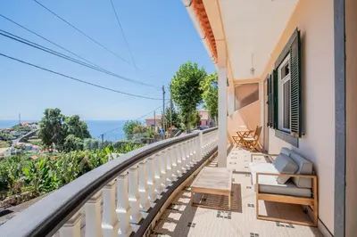 a balcony with chairs and a view of the ocean at Mill House in Ponta do Sol