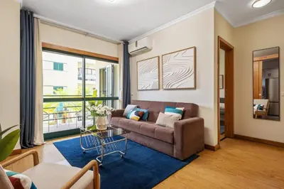 a living room with a couch and a blue rug at SUPER Anadia - Vintage in Funchal
