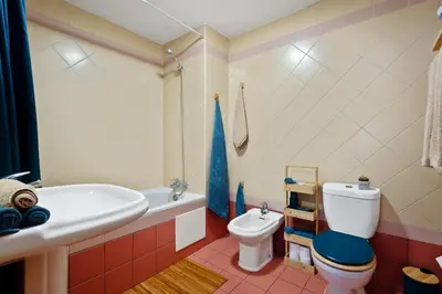 a bathroom with a tub and a toilet and a sink at SUPER Anadia - Vintage in Funchal