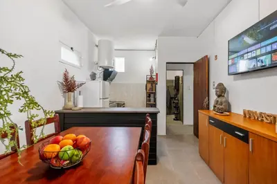 a kitchen with a table with a bowl of fruit on it at SUPER Zen in Ponta Delgada