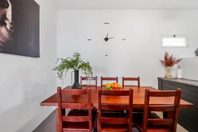 a dining room with a wooden table and chairs at SUPER Zen in Ponta Delgada