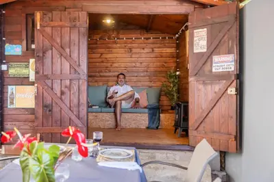 a man sitting on a couch in a wooden house at SUPER Zen in Ponta Delgada