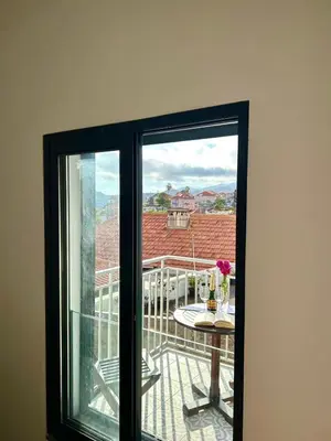 a window with a view of a balcony with a table at Casa Happy in Funchal