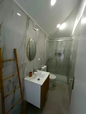a bathroom with a sink and a toilet and a mirror at Casa Happy in Funchal