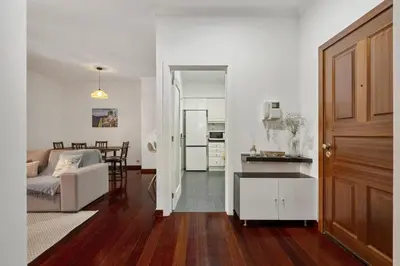 a living room and kitchen with a couch and a table at Doca's Refuge by Homie in Funchal