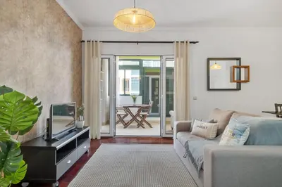 a living room with a couch and a tv at Doca's Refuge by Homie in Funchal