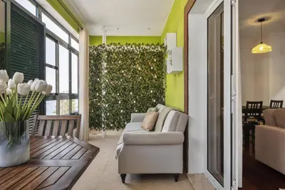 a living room with a couch and a plant at Doca's Refuge by Homie in Funchal