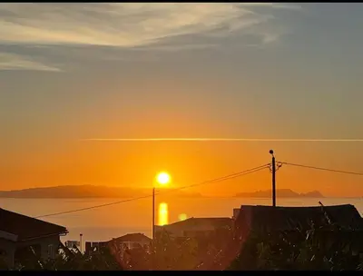 a sunset over the ocean with the sun in the sky at Garajau Madeira Holidays in Caniço