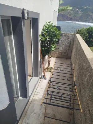 a set of stairs leading up to a building at Maresia Gardens in Porto da Cruz