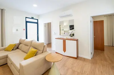 a living room with a couch and a table at Casa do Moinho by Mill Escapes in Funchal