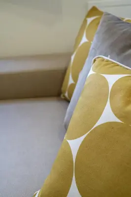 a bed with yellow and white sheets and pillows at Casa do Moinho by Mill Escapes in Funchal