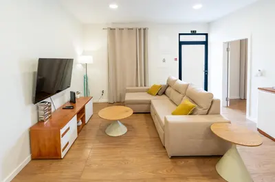 a living room with a couch and a tv at Casa do Moinho by Mill Escapes in Funchal