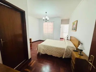 a bedroom with a bed and a window at Casa da Rochinha in Santa Cruz