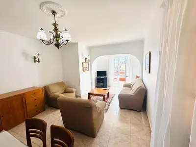 a living room with chairs and a couch and a table at Casa da Rochinha in Santa Cruz