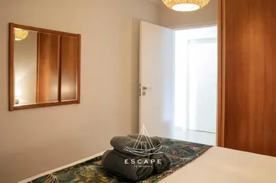 a room with a bed with a mirror and a pillow at Atlantic Flow House by Escape to Madeira in Arco da Calheta