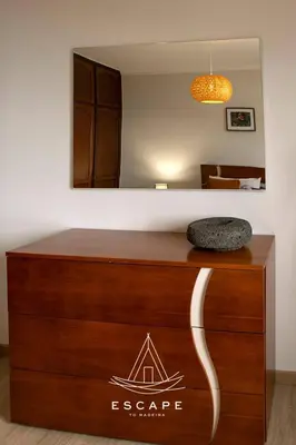 a sign on top of a dresser in a room at Atlantic Flow House by Escape to Madeira in Arco da Calheta