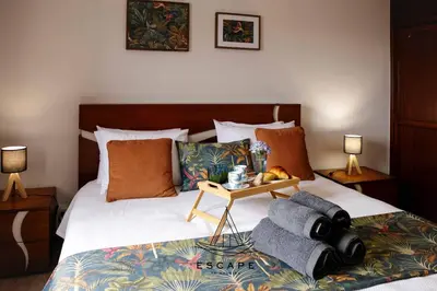 a bedroom with a bed with a tray with towels on it at Atlantic Flow House by Escape to Madeira in Arco da Calheta