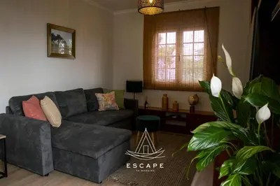 a living room with a couch and a table at Atlantic Flow House by Escape to Madeira in Arco da Calheta
