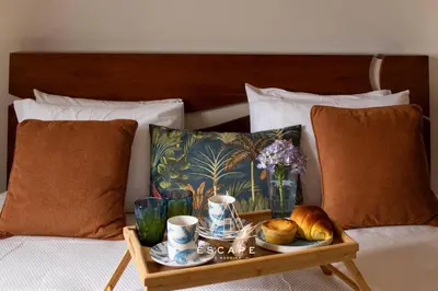 a tray of food on a bed with a tray of bread at Atlantic Flow House by Escape to Madeira in Arco da Calheta