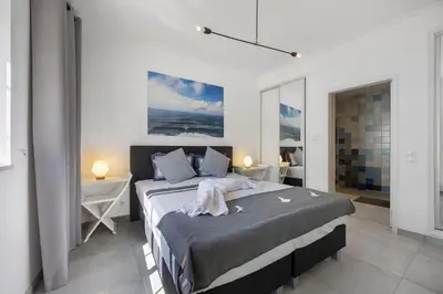 a bedroom with a large bed and two night stands at Casa Surfer’s Sanctuary - Algarve in Vila do Bispo