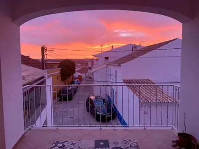 a view of a sunset from the balcony of a house at Casa Surfer’s Sanctuary - Algarve in Vila do Bispo