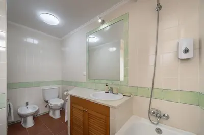 a hotel room with two beds and a window at Casa Encosta do Sol by An Island Apart in Porto Santo