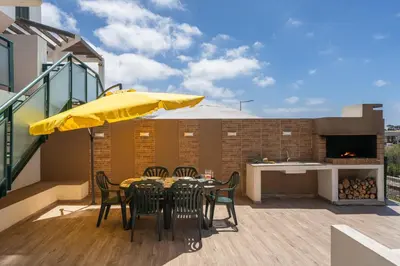 a living room with a couch and a table at Casa Encosta do Sol by An Island Apart in Porto Santo
