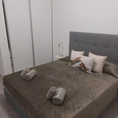 a bed with some pillows on top of it at Atlantic View Free Parking in Funchal